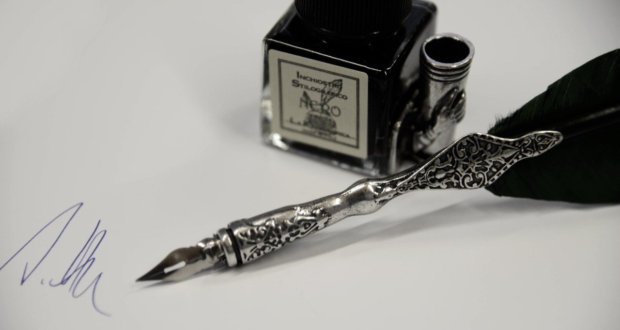 Tintenfass mit Feder, Symbolbild